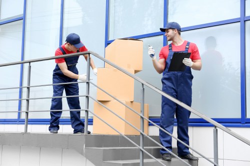 Workers wearing PPE during a house removal
