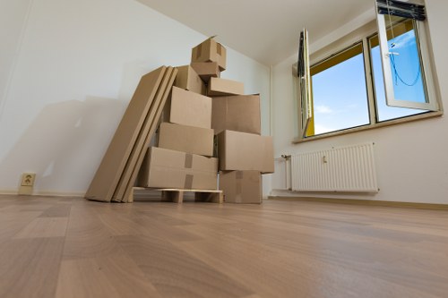Office staff logging a moving service complaint in a record system