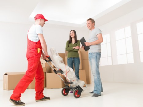 Staff using careful lifting techniques during a house removal