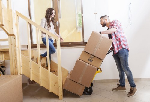 Students moving boxes and furniture with a Stockwell removals service
