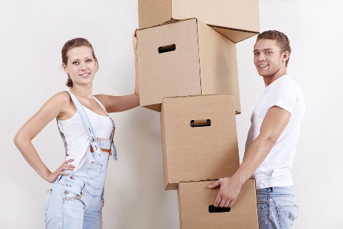 Professional movers carrying items through a flat entrance